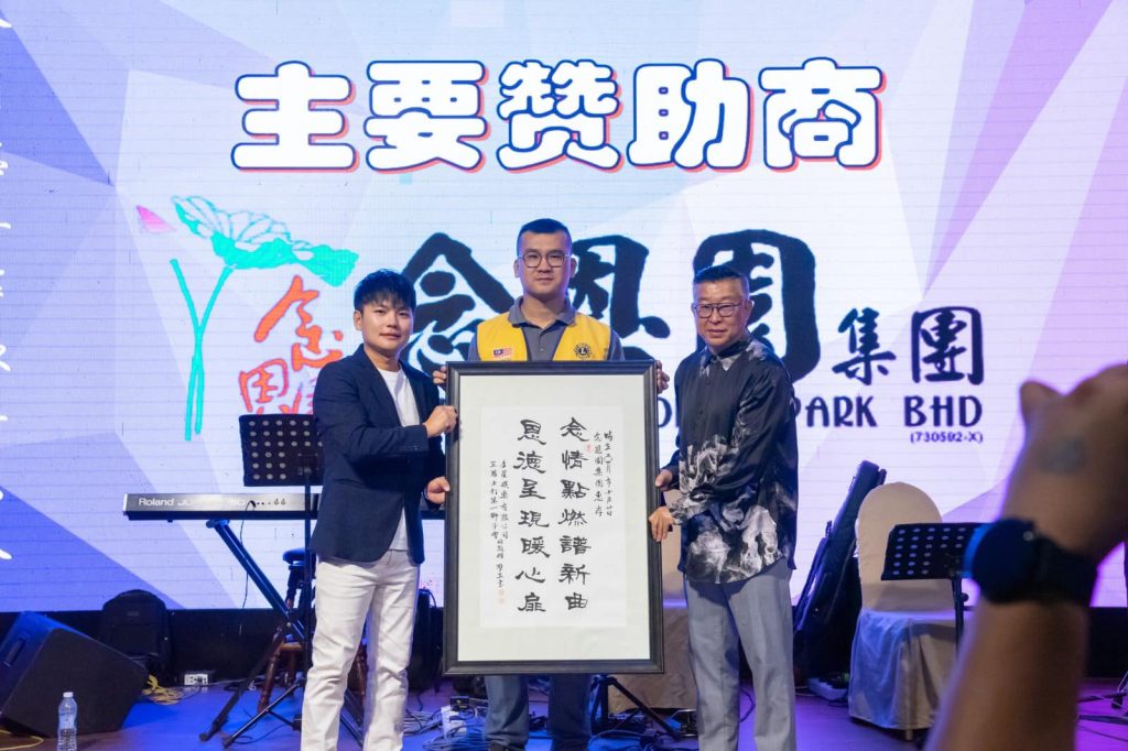 The image is decorative, its contains image of 3 people holding on one certificate of the program on the stage.